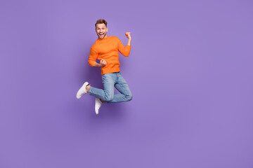 Fototapeta na wymiar Full body photo of good mood laughing man raise fists in victory win money lottery isolated on violet color background