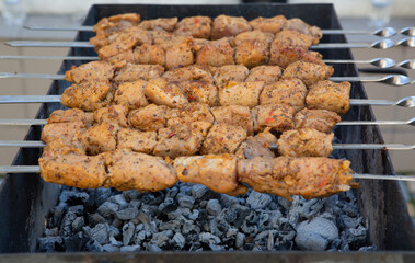 Shish kebab is prepared on a charcoal grill