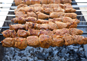 Shish kebab is prepared on a charcoal grill