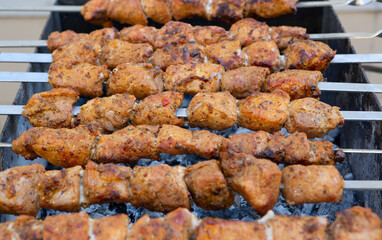 Shish kebab is prepared on a charcoal grill