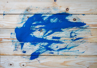 Blue paint on wooden background