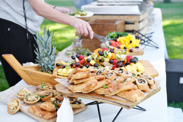 Self service food buffet. Guests at a relaxed party outdoor - obrazy, fototapety, plakaty