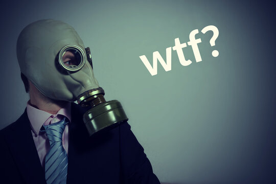 A man in a suit with a tie and a gas mask and wtf inscription, toned
