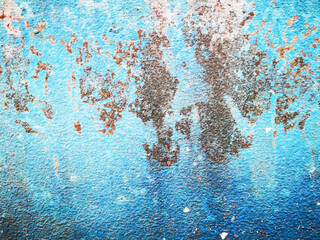 Old blue concrete wall with stains.
