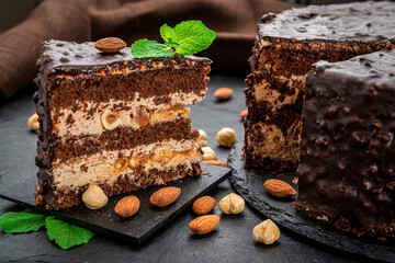Delicious caramel chocolate tart, topped with nuts and hazelnuts, almonds