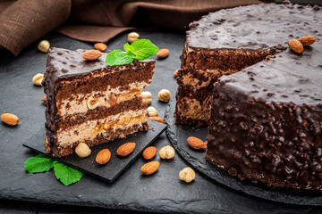 Delicious caramel chocolate tart, topped with nuts and hazelnuts, almonds