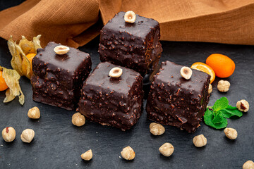 Delicious chocolate brownie with nuts on the table.