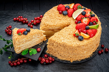Napoleon cake decorated with berries and fruits