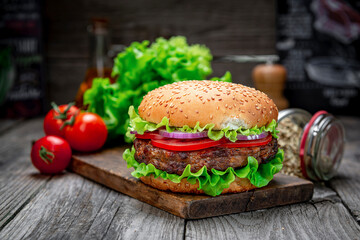 Fresh tasty burger on wood table