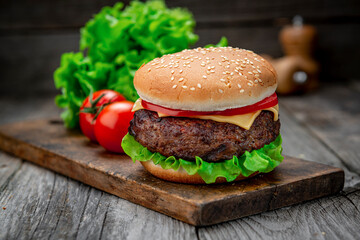 Fresh tasty burger on wood table