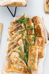 Pancakes stuffed with ham and cheese, chicken and vegetables on a banquet table