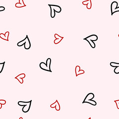 Seamless pattern of red and black hearts on a pink background