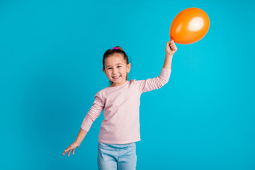 Portrait of cheerful funky person hold air ball toothy smile have good mood isolated on blue color background