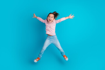 Fototapeta na wymiar Full size portrait of overjoyed cool pupil jumping have fun open mouth isolated on blue color background