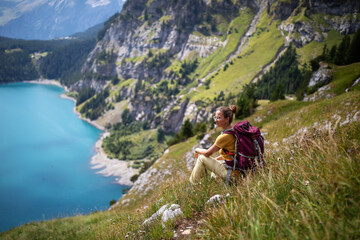 Tourist in the mountains in Switzerland on Lake Oeschinensee