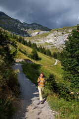 Fototapeta na wymiar Tourist in the mountains in Switzerland on Lake Oeschinensee