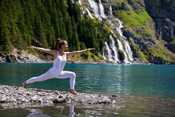 A woman practices yoga in the mountains