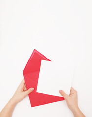  Female hands with pink envelope and blank card. Woman holding envelope square invitation card...