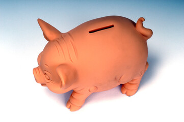 Pink piggy bank seen from above with neutral background