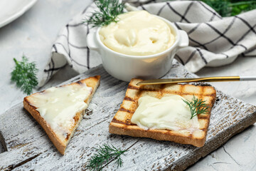 Sliced bread with cream cheese and butter for breakfast. melted cheese sandwich on light background. banner, menu, recipe place for text, top view