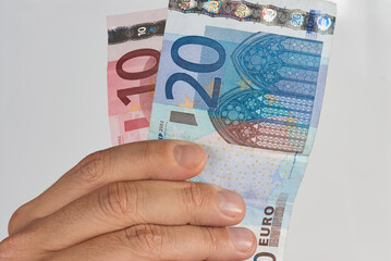 Hand picking up euro bills