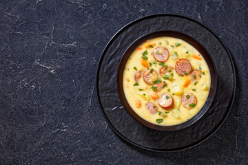 German potato soup with sausages in bowl