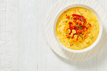 savory creamy pumpkin soup in bowl, top view