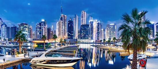 Marina with yachts and skyscrapers in Dubai UAE with Burj Khalifa at night. - obrazy, fototapety, plakaty