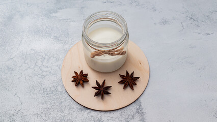 Obraz na płótnie Canvas Vegetarian milk and star anise on wooden board. Alternative drinks for autumn, fall season. Organic homemade food. Non lactose.