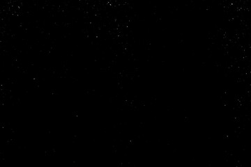 Chaotic white star bokeh on a isolated black background. falling blurry bokeh snow overlay, starry sky. white spots on black background, white drops and spots. abstraction