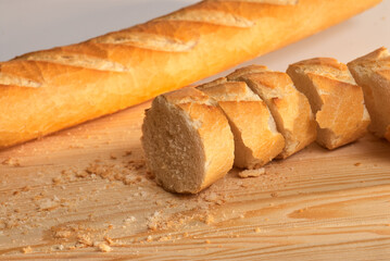 Bread slices on a wooden board with crumbs around
