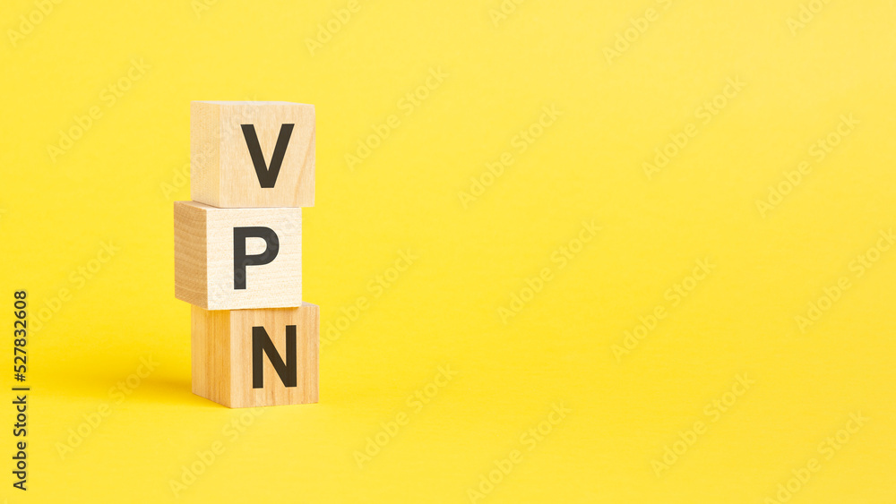 Poster vpn - virtual private network - text on wooden block with yellow background.