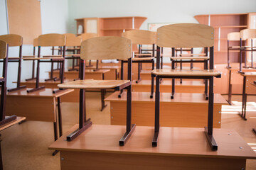 empty school classroom background without young student. view of class room no kid or teacher with chairs and tables in campus