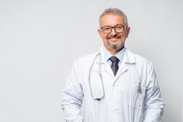 Horizontal Portrait of serious mature male doctor or therapist in white medical uniform, glasses...