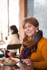  Cute old lady enjoying coffee at outdoor cafe stock photo