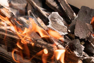 Burning wooden firewood close-up. tongues of flame. background texture fire