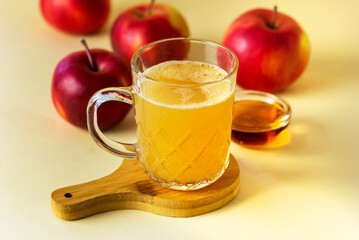 Fresh and Tasty Homemade Apple Cider with Ground Cinnamon Raw Red Apples Glass Mug with Cider on Wooden Stand Horizontal