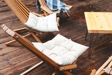 Wooden Chairs and Wooden Table on Wooden Platform after Rain Horizontal