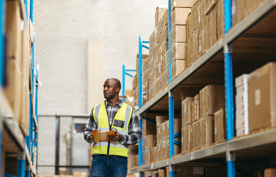 Warehouse supervisor taking inventory in a large logistics centre