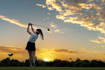 Professional woman golfer teeing golf in golf tournament competition at golf course for winner	