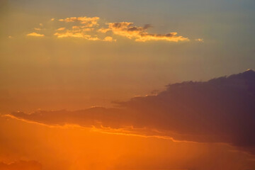 Fototapeta premium Magnificent bright colorful sky at sunset, nature landscape. Sun's rays break through clouds. Copy space. Soft focus