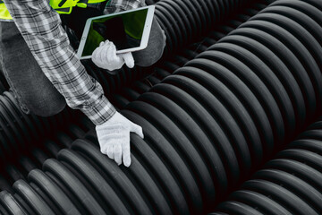 worker checking hdpe corrugated pipe