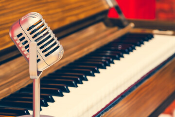retro microphone on acoustic piano background