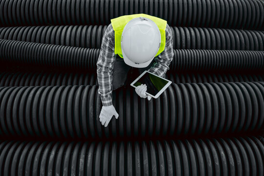 worker checking hdpe corrugated pipe