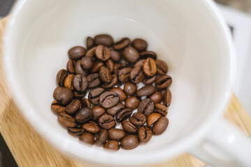Roasted coffee beans inside the cup