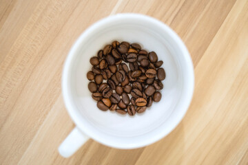 Roasted coffee beans inside the cup