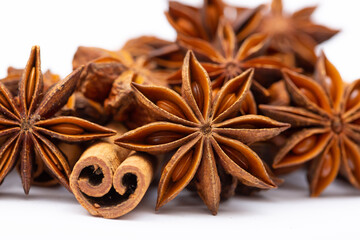 Star anise and cinnamon sticks on a white background isolated. Indian spices close up. Medicinal herbs and spices.