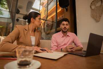 Confused businessman and businesswoman can't solve their problem