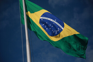 salvador, bahia, brazil - august 25, 2022: Brazil flag on a flagpole of a supermarket in Cabula neighborhood in Salvador city. - obrazy, fototapety, plakaty