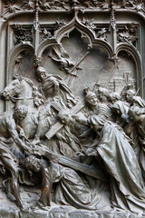 Milan Duomo door relief sculptures. Jesus carrying his cross.